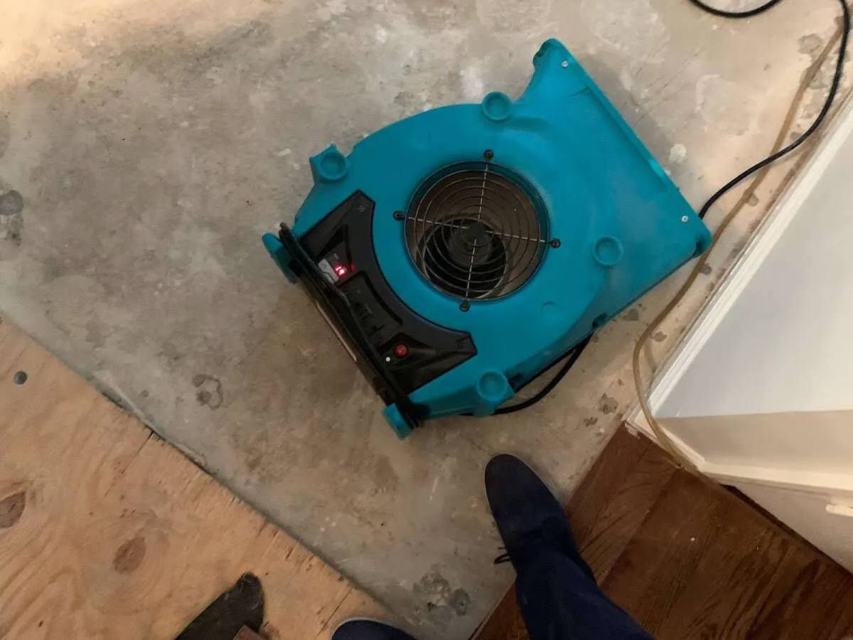 Air mover drying subfloor during Commercial Water Damage Restoration in Pleasant Grove